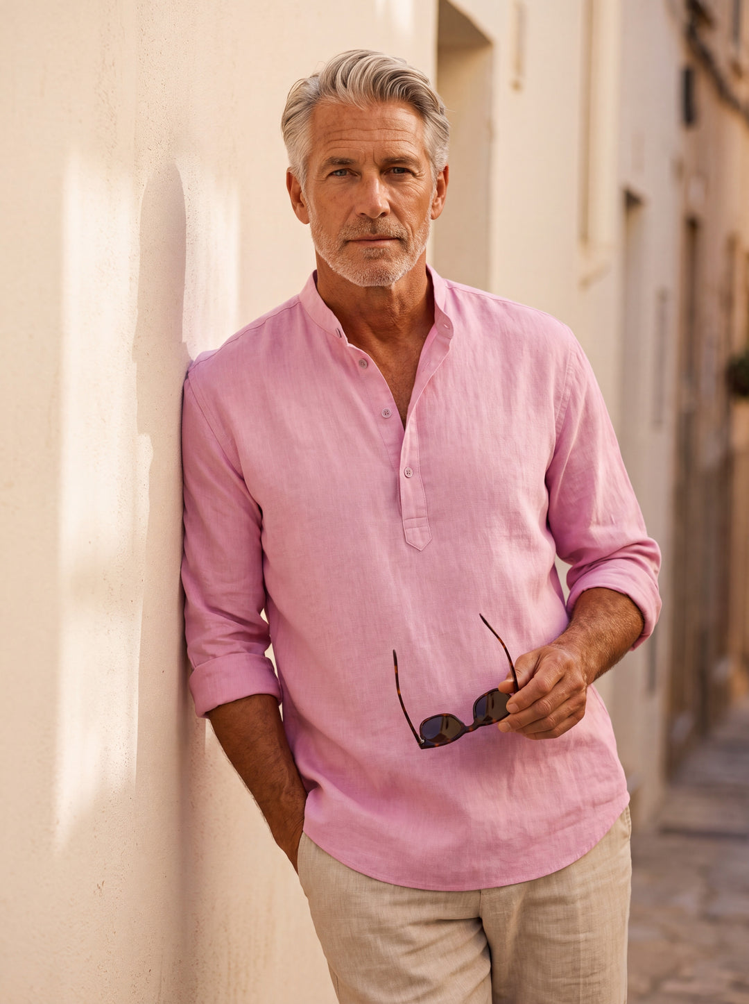 Caleb Men linen shirt in pink, worn by a model on a Mediterranean terrace - Gentlemens Manor lifestyle