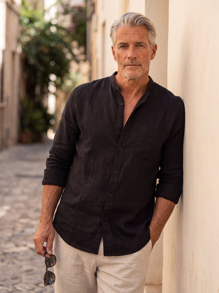 Carl Men linen shirt in black, worn by a model on a Mediterranean terrace - Gentlemens Manor lifestyle