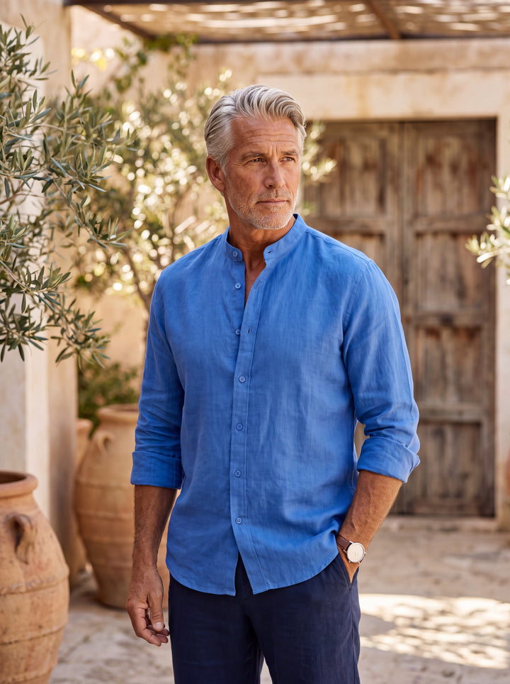 Carl Men linen shirt in blue, worn by a model on a Mediterranean terrace - Gentlemens Manor lifestyle