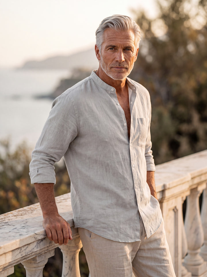 Carl Men linen shirt in light grey, worn by a model on a Mediterranean terrace - Gentlemens Manor lifestyle