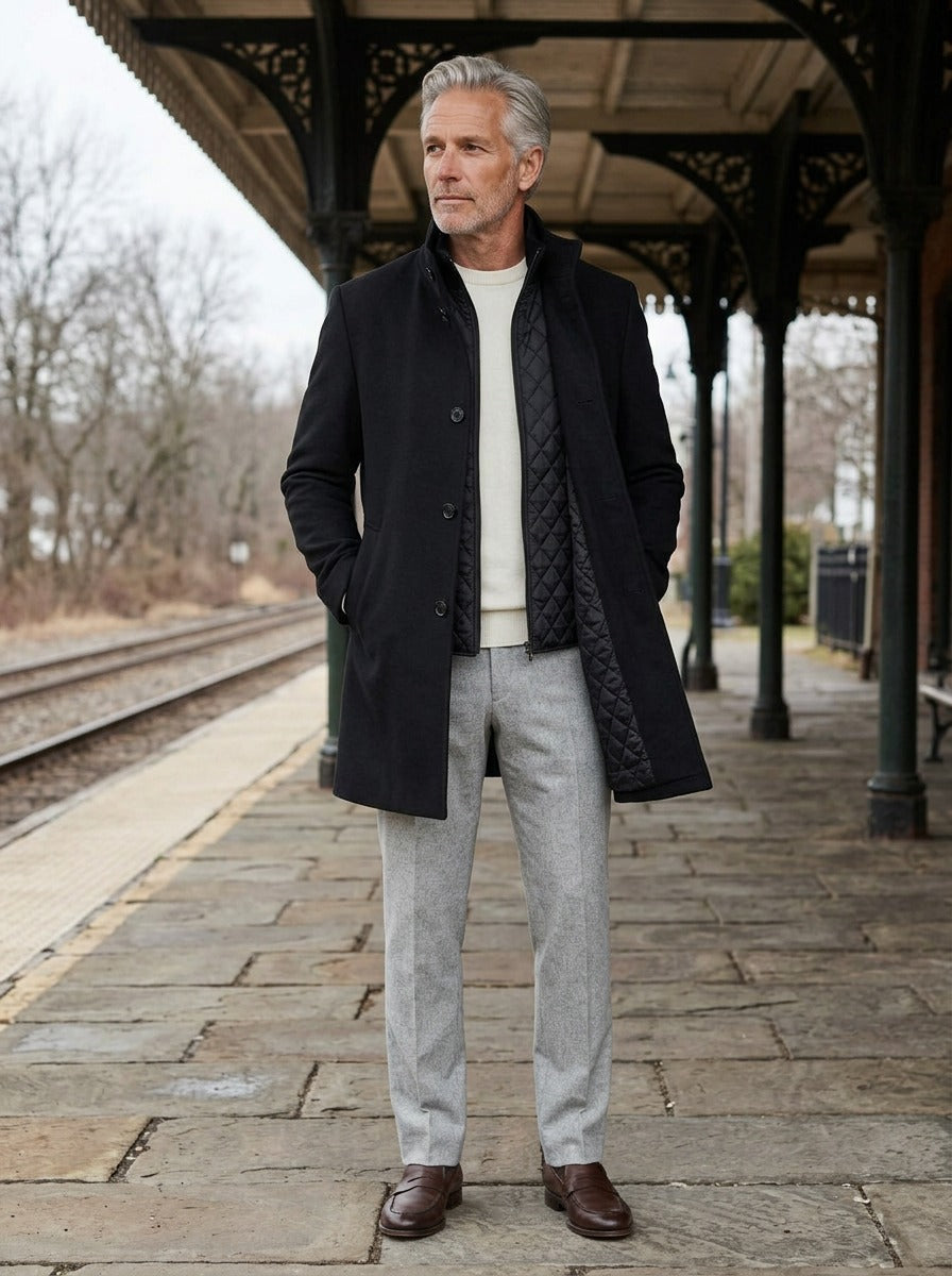 Carlisle coat in Black, lifestyle on a railway platform, Gentlemens Manor
