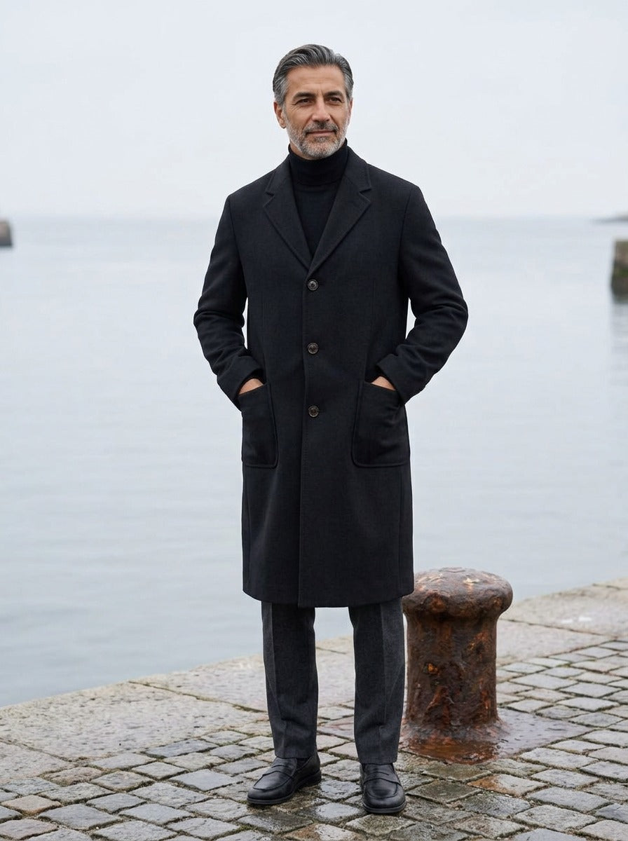Carmichael overcoat in Black, lifestyle on a stone harbor quay, Gentlemens Manor