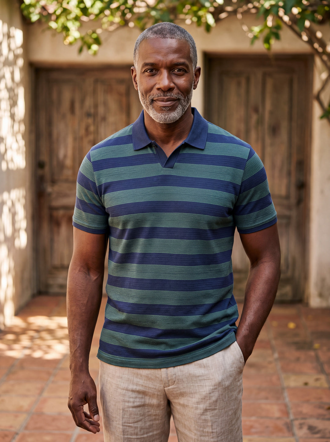 Carson Men polo shirt in blue, worn by a model on a Mediterranean terrace - Gentlemens Manor lifestyle