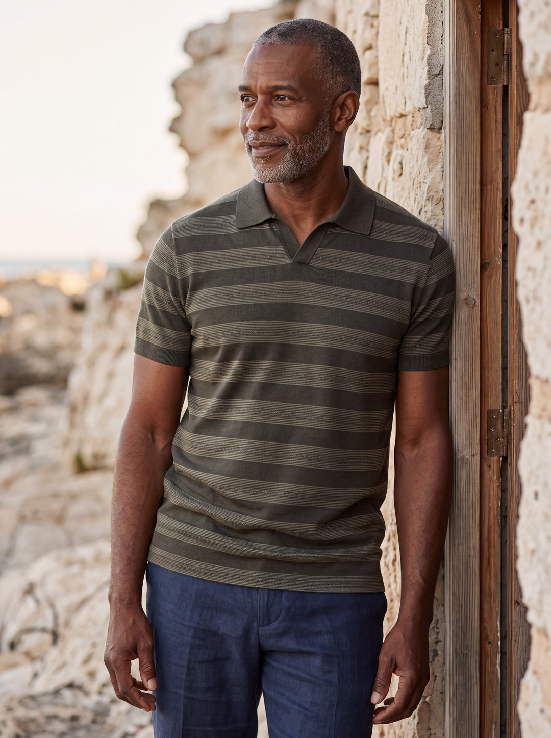 Carson Men polo shirt in olive, worn by a model on a Mediterranean terrace - Gentlemens Manor lifestyle