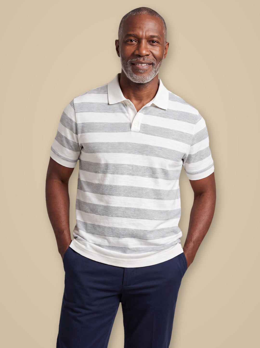 Carson polo shirt in White, worn by a model on a warm taupe studio background - Gentlemens Manor