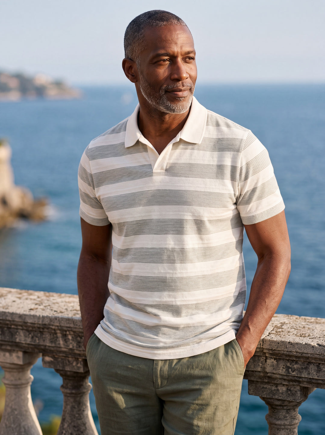 Carson Men polo shirt in white, worn by a model on a Mediterranean terrace - Gentlemens Manor lifestyle