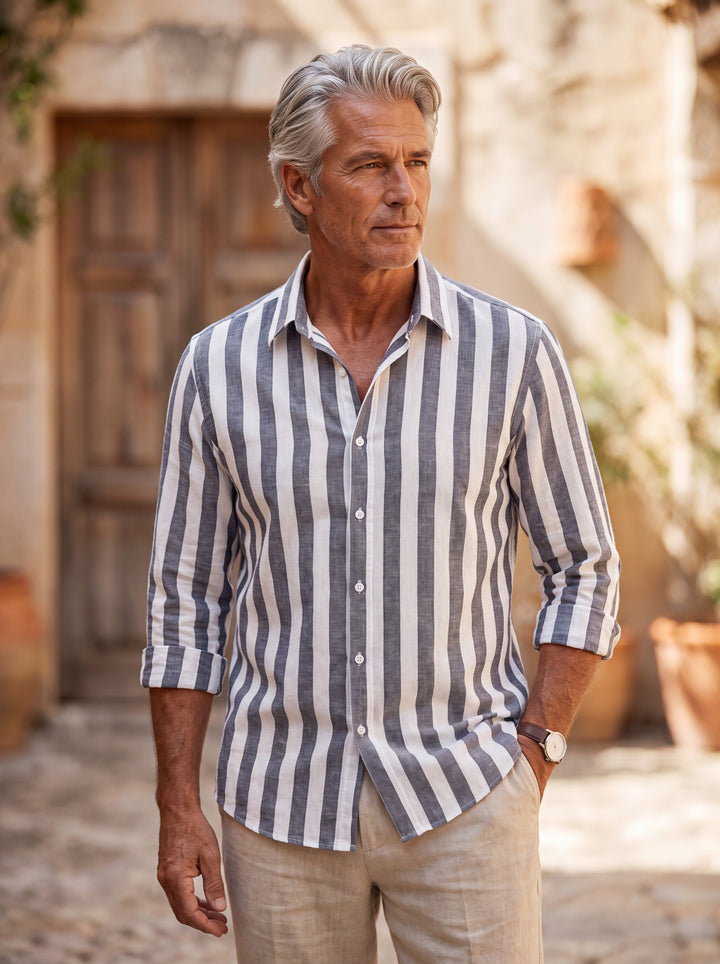 Chandler Men linen shirt in Charcoal, worn by a model on a Mediterranean terrace - Gentlemens Manor lifestyle