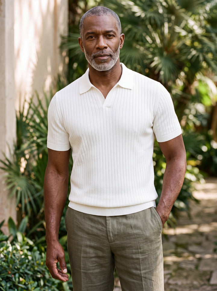 Clarence Men polo shirt in white, worn by a model on a Mediterranean terrace - Gentlemens Manor lifestyle