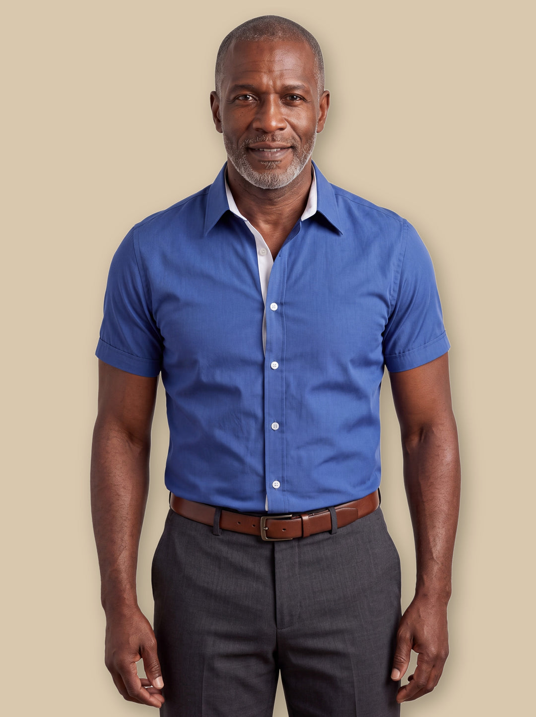 Clark dress shirt in Blue, worn by a model on a warm sand studio background - Gentlemens Manor