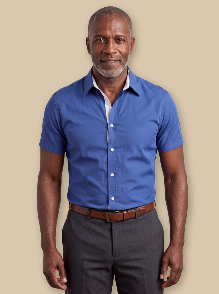 Clark dress shirt in Blue, worn by a model on a warm sand studio background - Gentlemens Manor