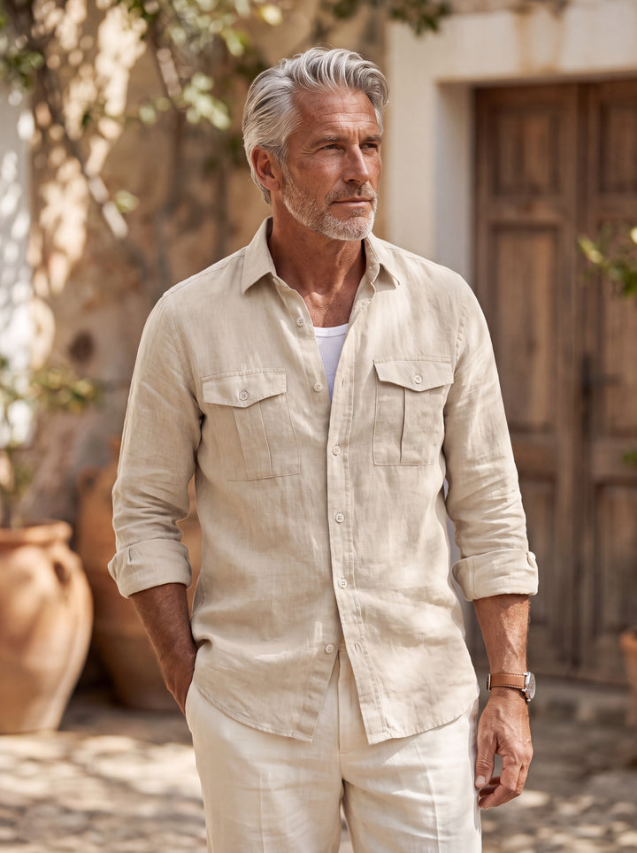 Clayton Men linen shirt in Sand, worn by a model on a Mediterranean terrace - Gentlemens Manor lifestyle