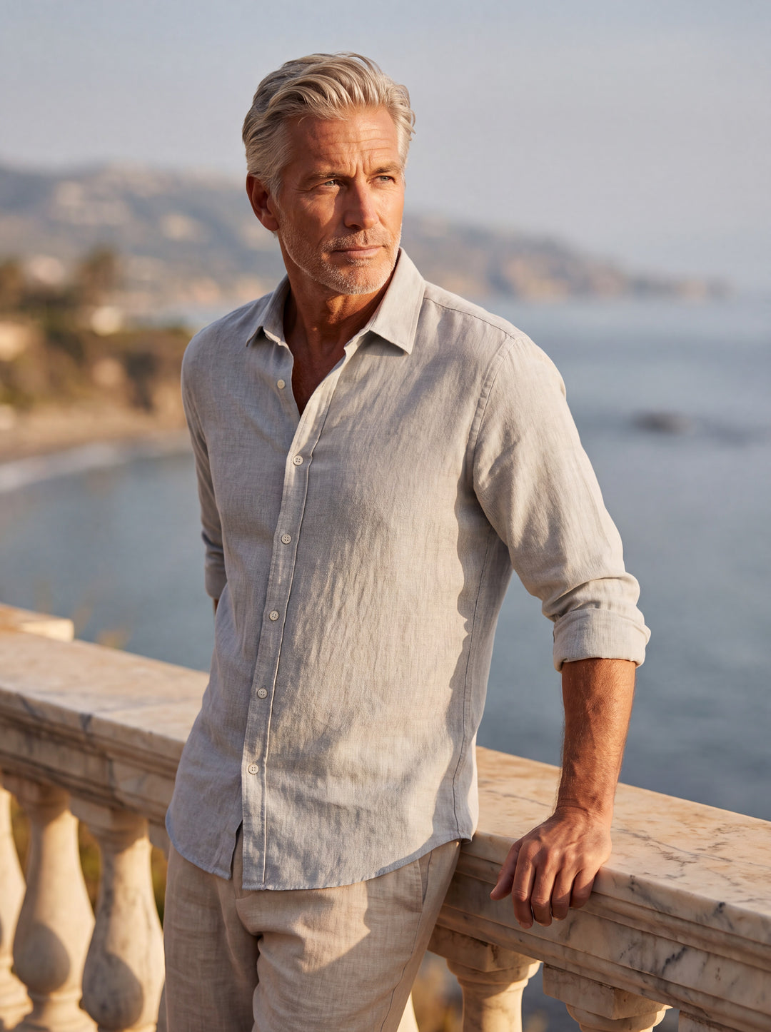 Clement Men linen shirt in Grey, worn by a model on a Mediterranean terrace - Gentlemens Manor lifestyle
