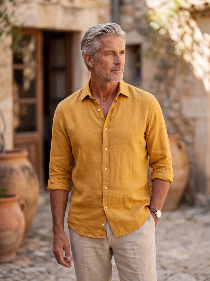 Clement Men linen shirt in Mustard, worn by a model on a Mediterranean terrace - Gentlemens Manor lifestyle