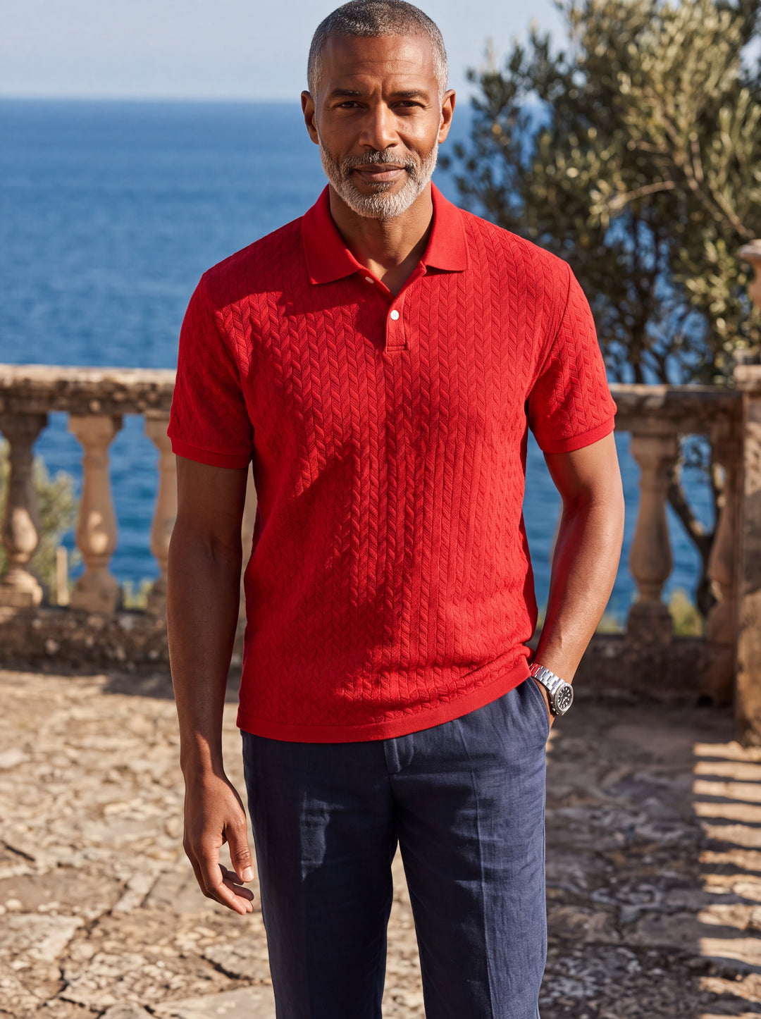 Clifford Men polo shirt in red, worn by a model on a Mediterranean terrace - Gentlemens Manor lifestyle