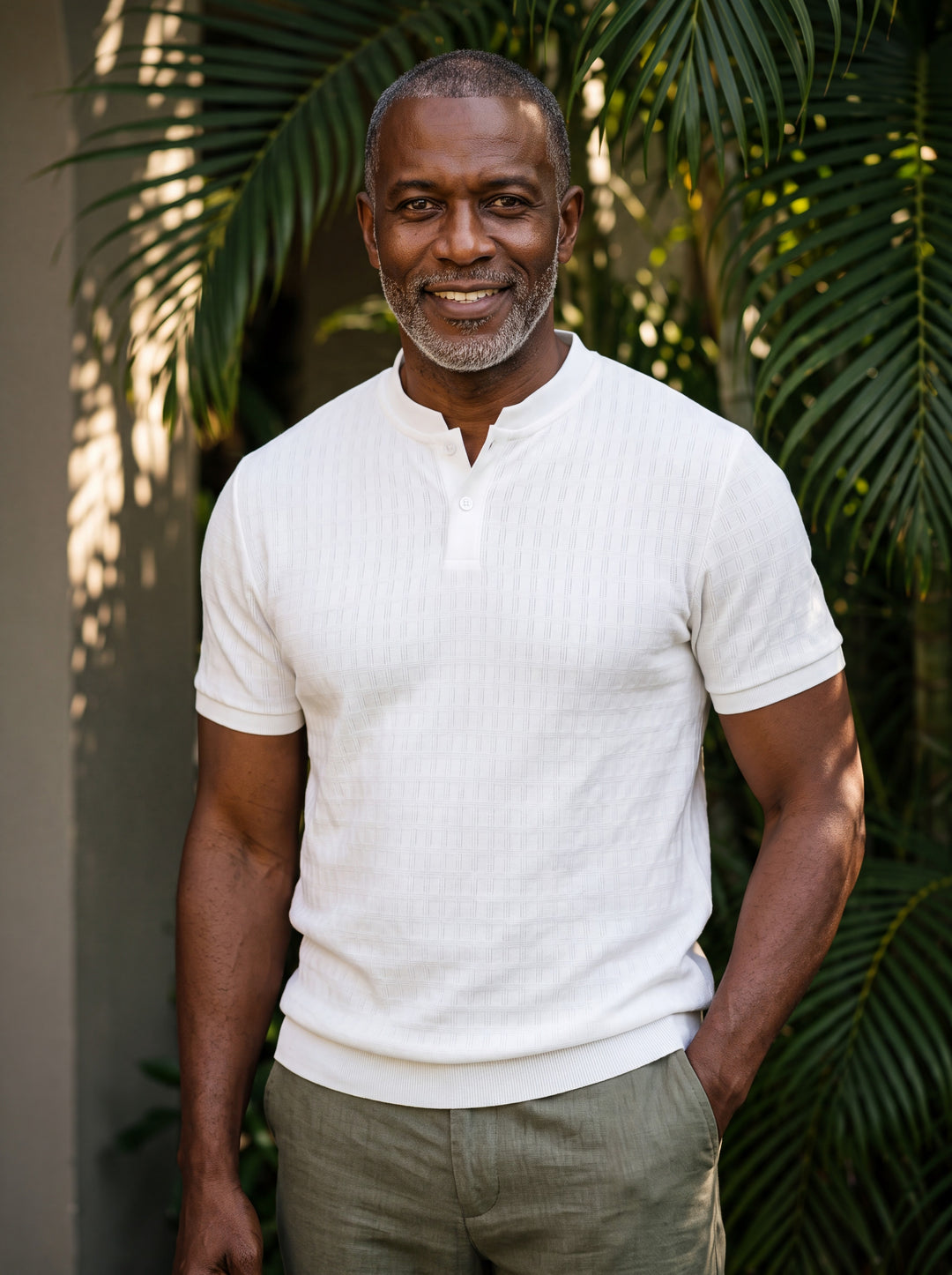 Clifford Men polo shirt in white, worn by a model on a Mediterranean terrace - Gentlemens Manor lifestyle