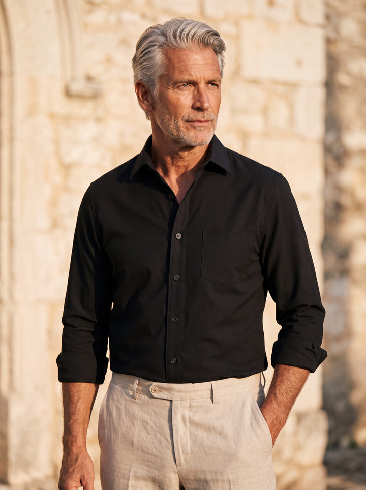 Clifton shirt in Black, worn by a model in a Mediterranean setting - Gentlemens Manor lifestyle