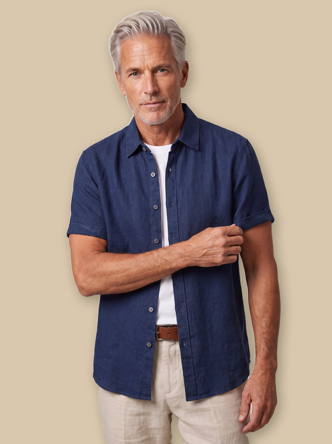 Cole linen shirt in Navy, worn by a model on a warm sand studio background - Gentlemens Manor