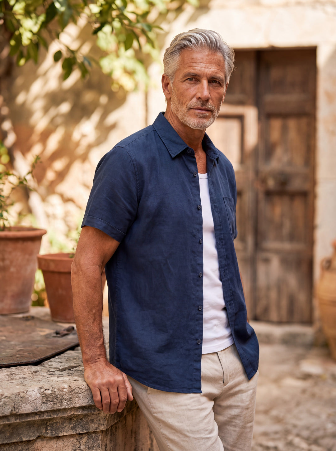 Cole Men short sleeve shirt in Navy, worn by a model on a Mediterranean terrace - Gentlemens Manor lifestyle