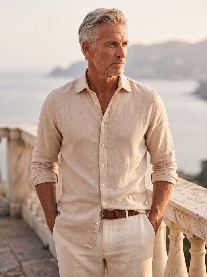 Coleman Men beach shirt in Sand, worn by a model on a Mediterranean terrace - Gentlemens Manor lifestyle