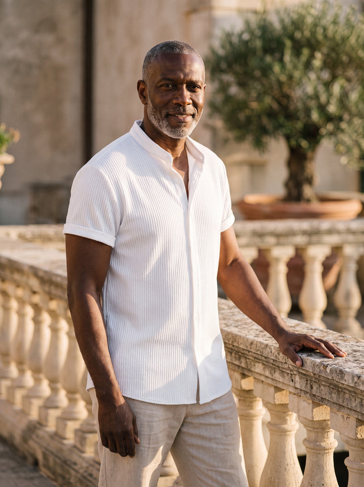 Corbin Men short sleeve shirt in white, worn by a model on a Mediterranean terrace - Gentlemens Manor lifestyle