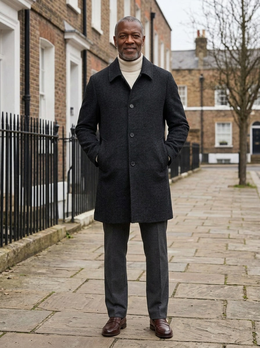 Crandall herringbone overcoat in Black, lifestyle on a street of brick row houses, Gentlemens Manor