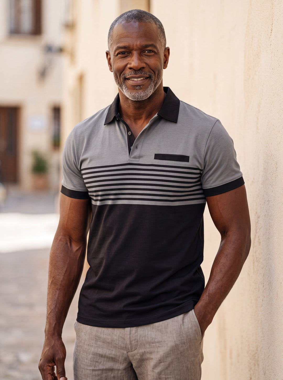 Crawford Men polo shirt in charcoal, worn by a model on a Mediterranean terrace - Gentlemens Manor lifestyle