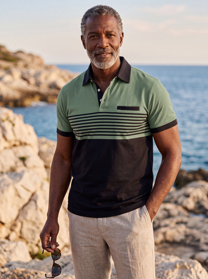 Crawford Men polo shirt in green, worn by a model on a Mediterranean terrace - Gentlemens Manor lifestyle