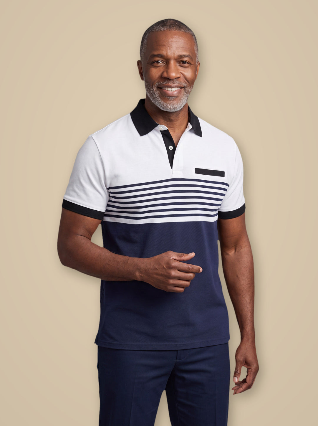 Crawford polo shirt in White, worn by a model on a warm taupe studio background - Gentlemens Manor