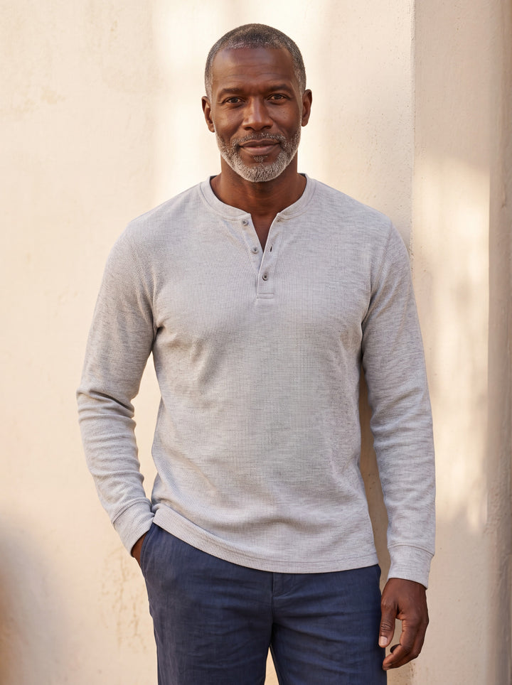 Cyrus Men henley shirt in grey, worn by a model on a Mediterranean terrace - Gentlemens Manor lifestyle