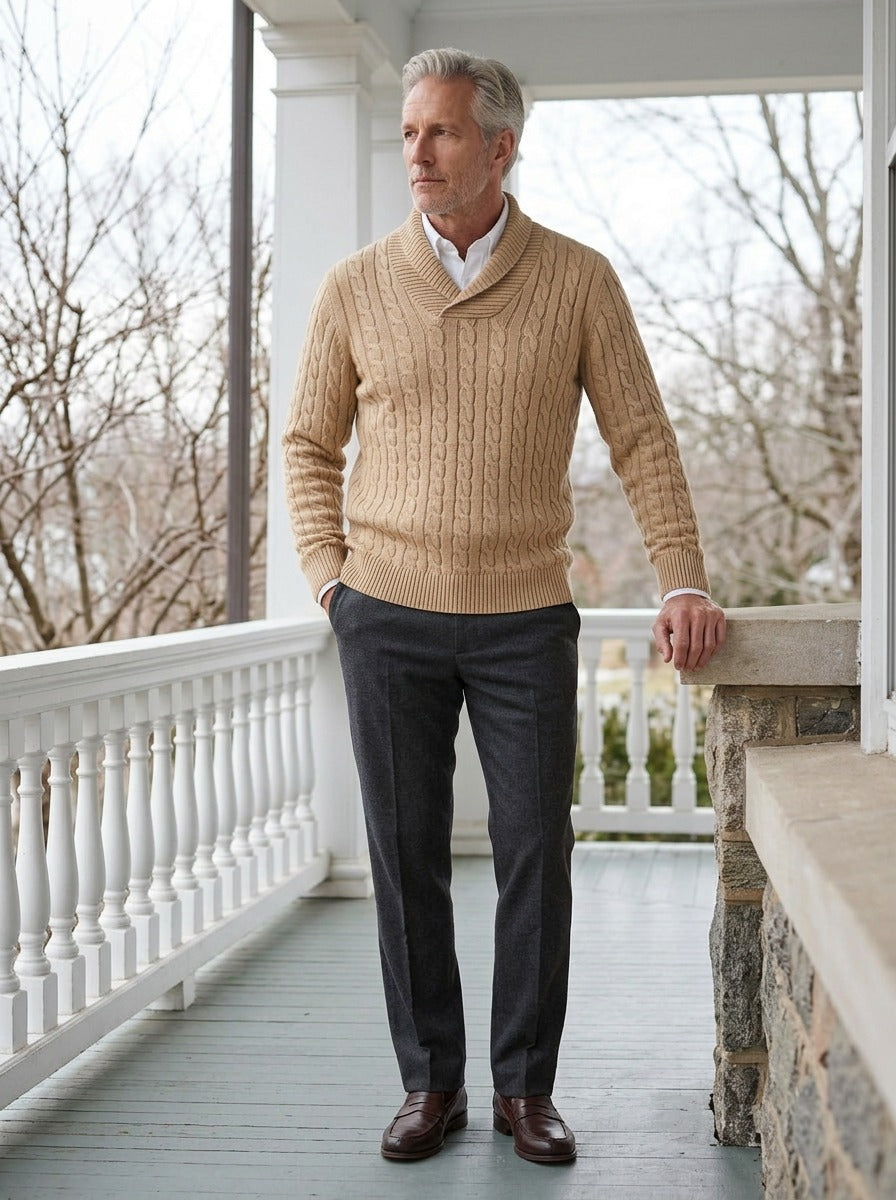Dalby cable knit shawl collar sweater in Sand, lifestyle on a covered porch, Gentlemens Manor