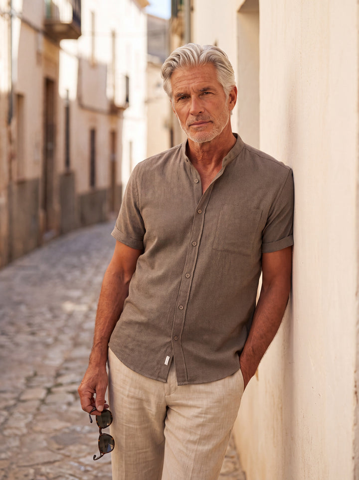 Dana Men short sleeve shirt in Grey, worn by a model on a Mediterranean terrace - Gentlemens Manor lifestyle