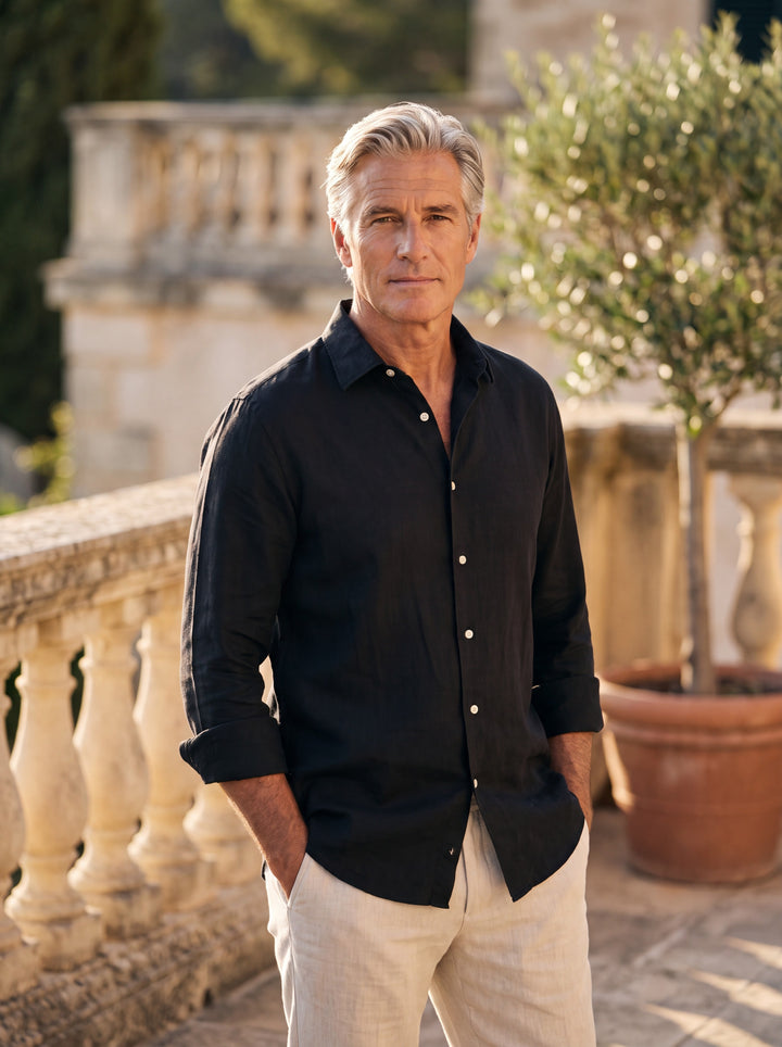 Dane Men linen shirt in black, worn by a model on a Mediterranean terrace - Gentlemens Manor lifestyle