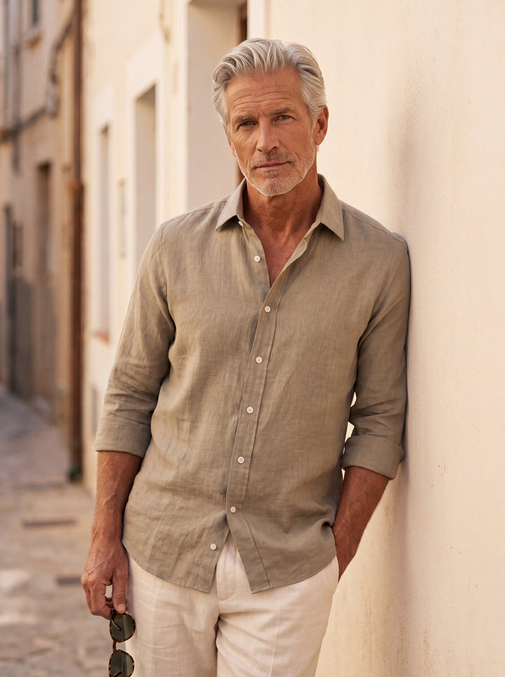 Daniel Men linen shirt in Sand, worn by a model on a Mediterranean terrace - Gentlemens Manor lifestyle