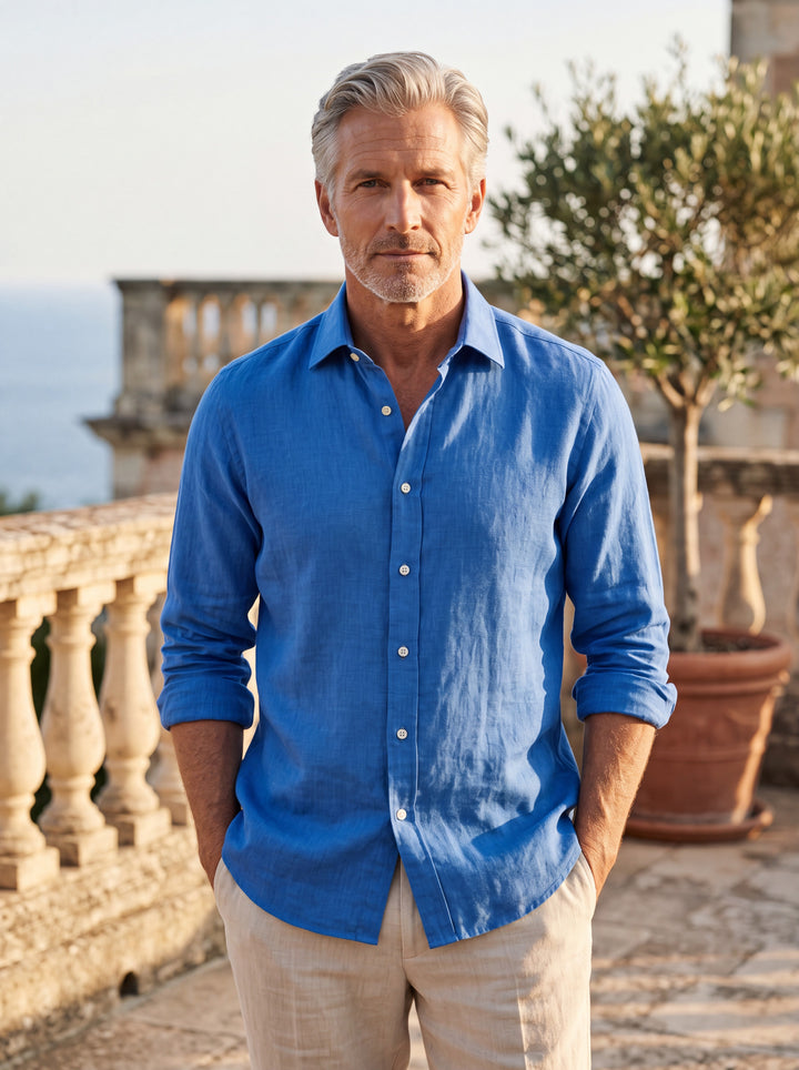 Daniel Men linen shirt in Blue, worn by a model on a Mediterranean terrace - Gentlemens Manor lifestyle