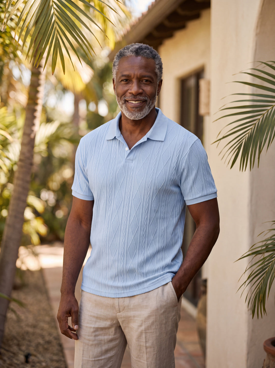 Darby Men polo shirt in Light Blue, worn by a model on a Mediterranean terrace - Gentlemens Manor lifestyle