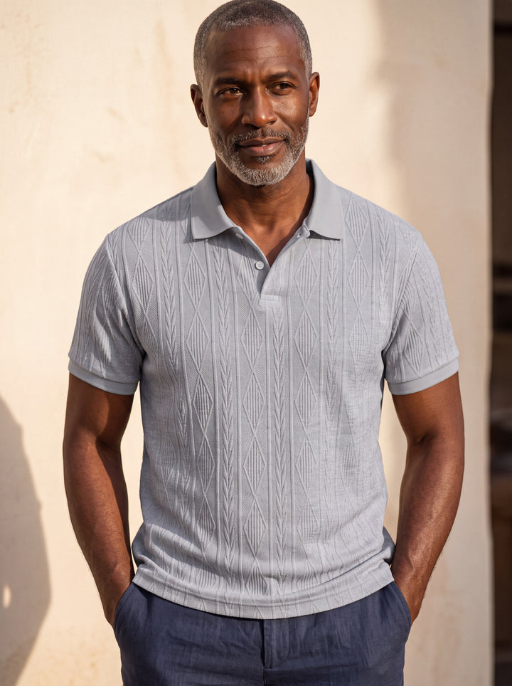 Darby Men polo shirt in Light Grey, worn by a model on a Mediterranean terrace - Gentlemens Manor lifestyle