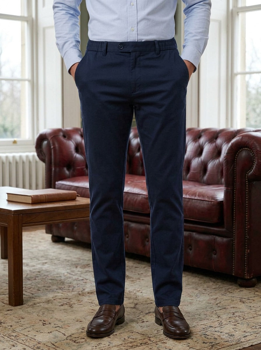 Dashiell elastic waist stretch trousers in Navy, lifestyle in a club reading room, Gentlemens Manor