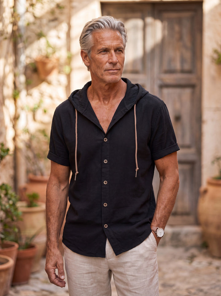 Dawson Men linen shirt in black, worn by a model on a Mediterranean terrace - Gentlemens Manor lifestyle
