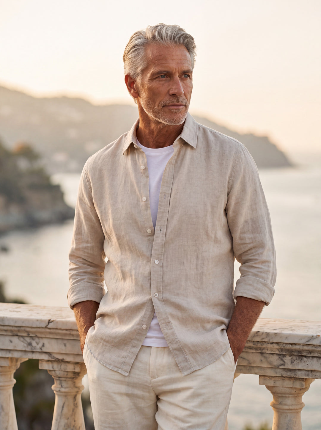 Dean Men linen shirt in Sand, worn by a model on a Mediterranean terrace - Gentlemens Manor lifestyle