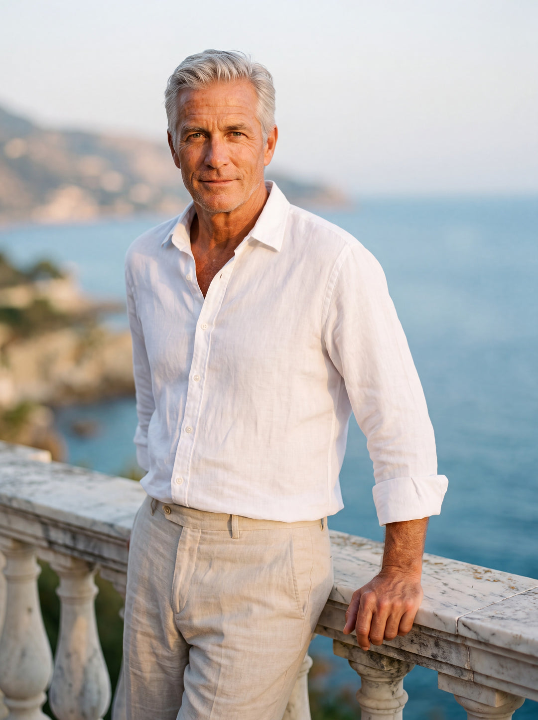Dean Men linen shirt in white, worn by a model on a Mediterranean terrace - Gentlemens Manor lifestyle