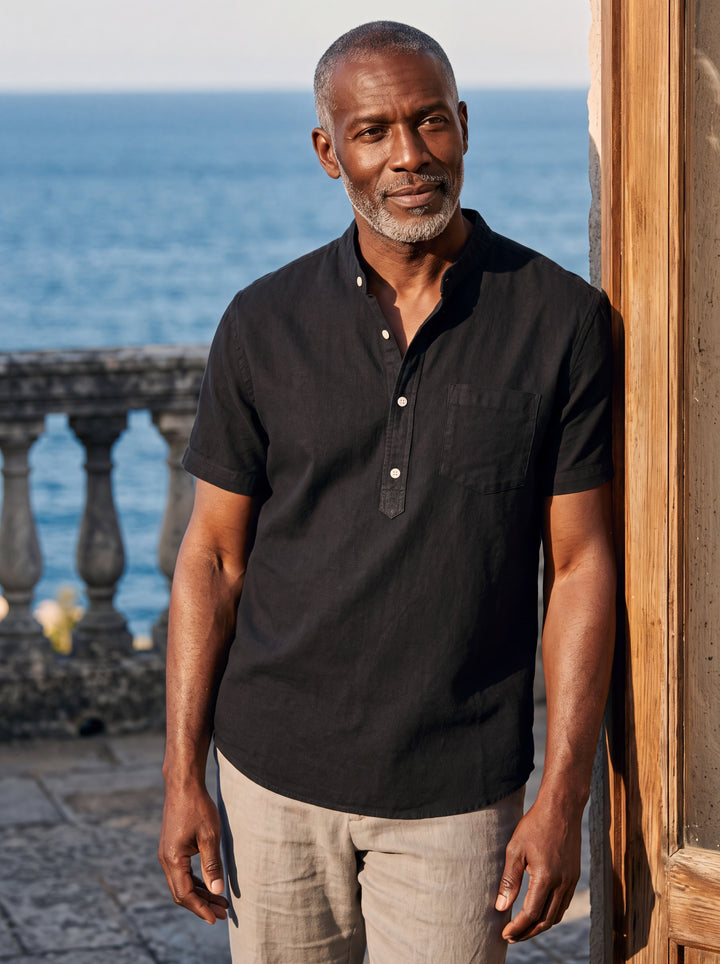 Denver Men henley shirt in black, worn by a model on a Mediterranean terrace - Gentlemens Manor lifestyle
