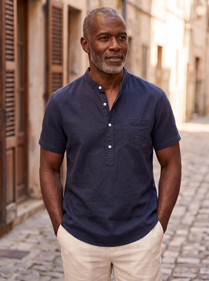 Denver Men henley shirt in navy, worn by a model on a Mediterranean terrace - Gentlemens Manor lifestyle