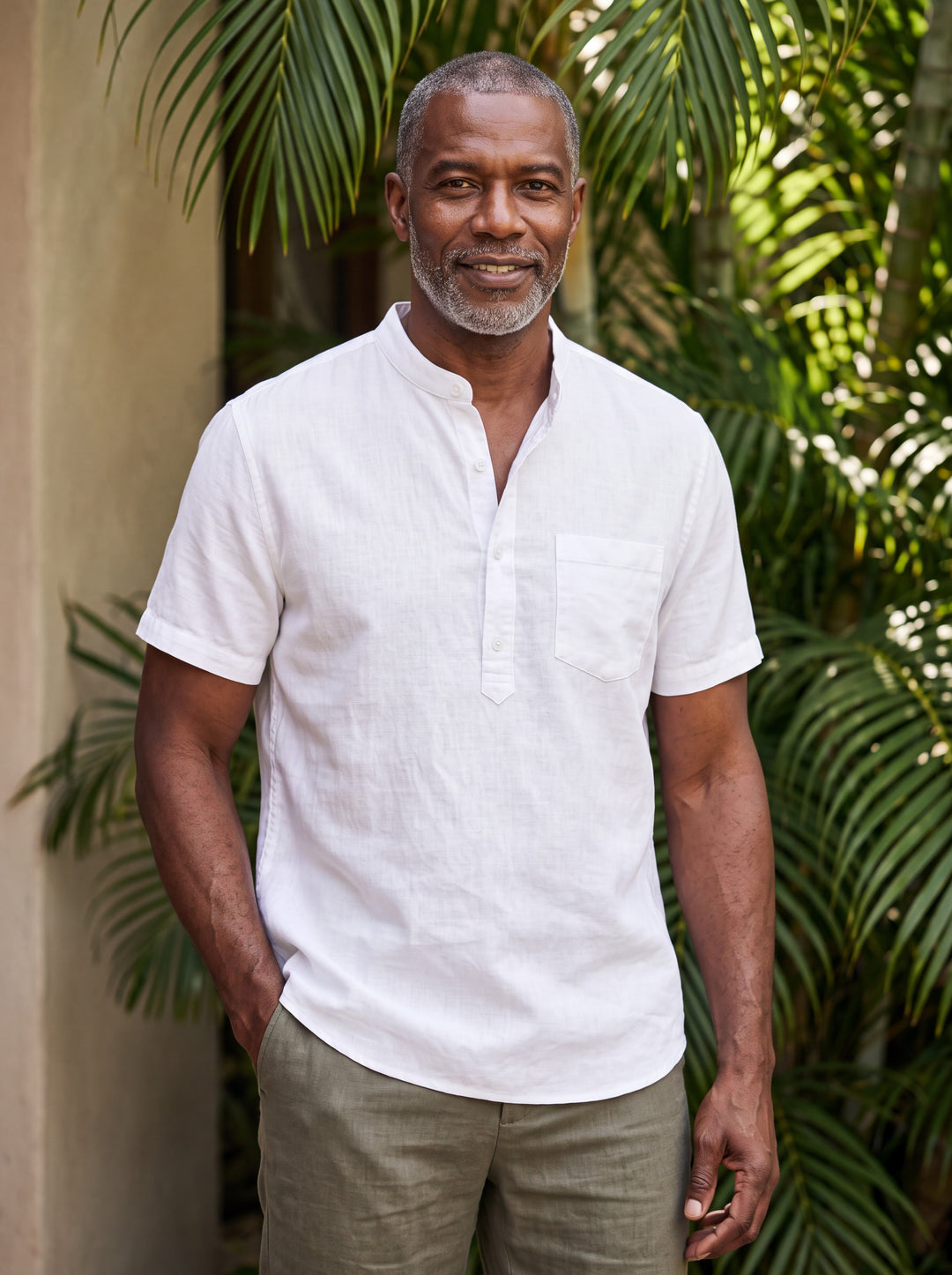 Denver Men henley shirt in white, worn by a model on a Mediterranean terrace - Gentlemens Manor lifestyle