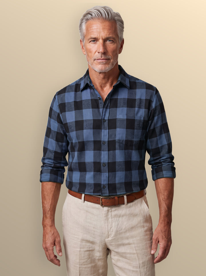 Dominic casual shirt in Blue, worn by a model on a warm sand studio background - Gentlemens Manor