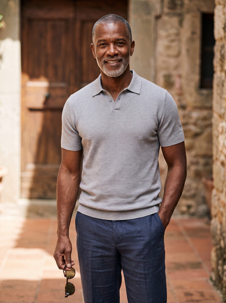 Donald Men polo shirt in grey, worn by a model on a Mediterranean terrace - Gentlemens Manor lifestyle
