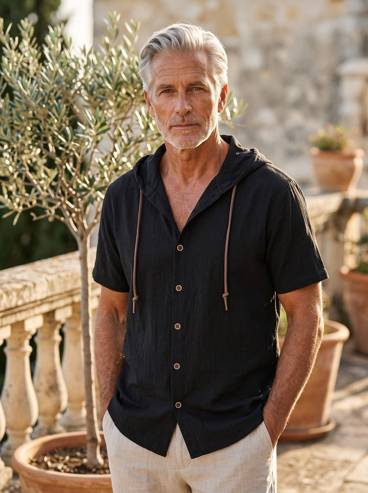 Drake Men hooded top in black, worn by a model on a Mediterranean terrace - Gentlemens Manor lifestyle