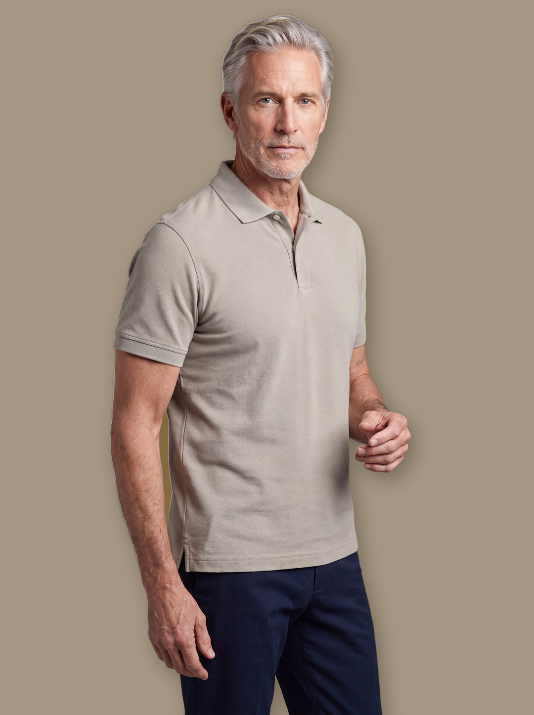 Dudley polo shirt in White, worn by a model on a warm taupe studio background - Gentlemens Manor