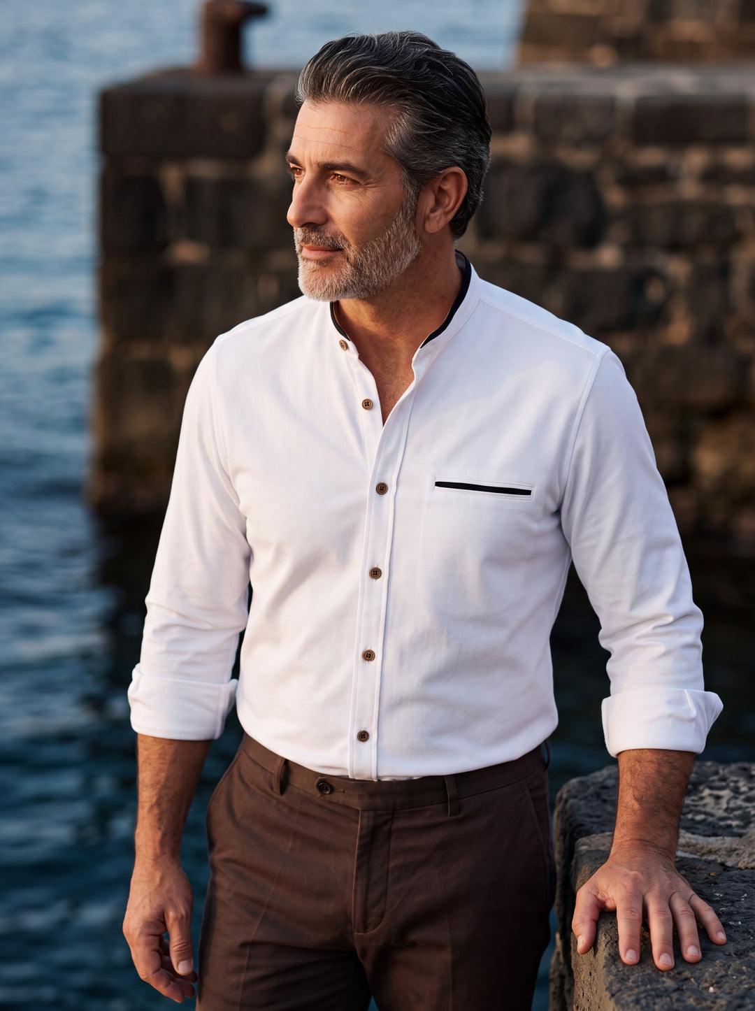 Edgar shirt in White, worn by a model in a Mediterranean setting - Gentlemens Manor lifestyle