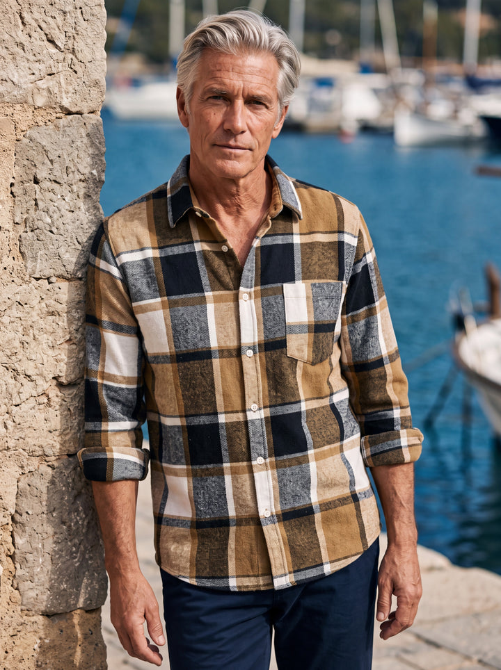 Edmund shirt in Sand, worn by a model in a Mediterranean setting - Gentlemens Manor lifestyle