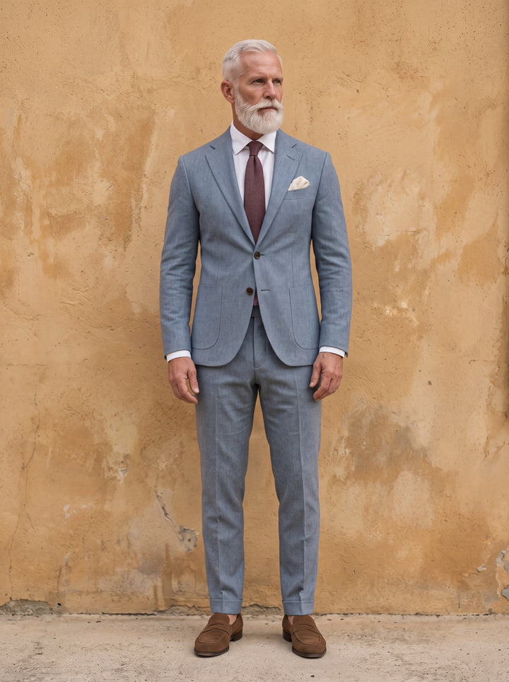 Elliott Men two-piece suit in light blue, worn by a model in a Mediterranean setting - Gentlemens Manor lifestyle